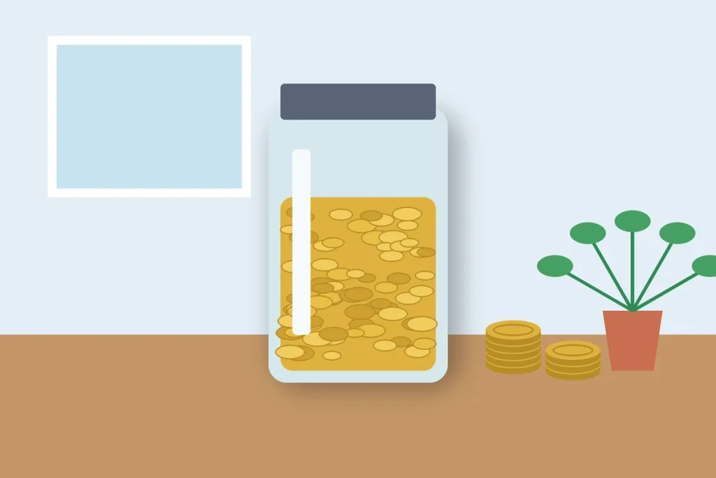 Glass savings jar full of coins representing the 20% savings goal in a 50/30/20 budget