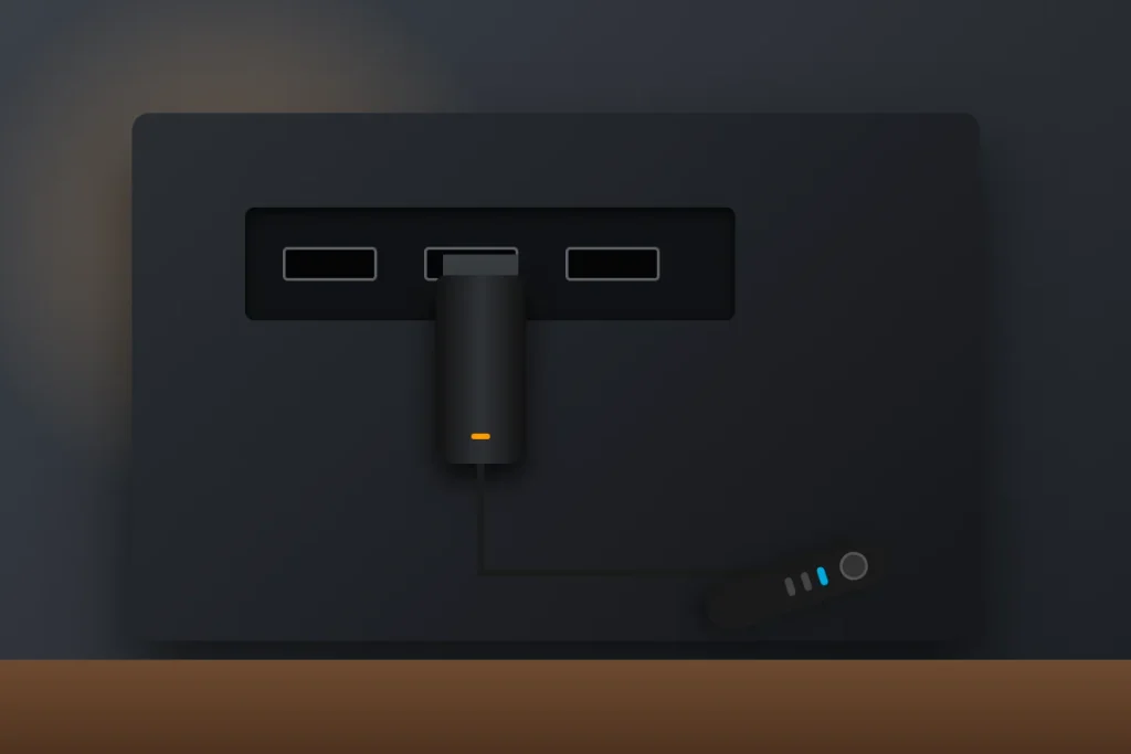 Fire TV Stick plugged into the HDMI port on the back of a TV for 9Now on Firestick
